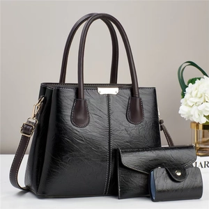 Three-piece black faux leather handbag set with tote, wallet and pouch in retro style
