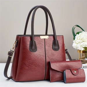 Three-piece burgundy faux leather handbag set with tote, wallet and mini card holder