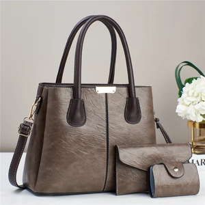 Detailed set of taupe synthetic leather handbags with gold hardware and contrast stitching