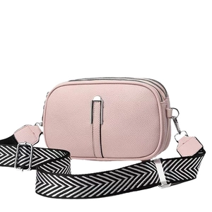 Pink lychee texture crossbody bag with triple zippers and woven patterned strap