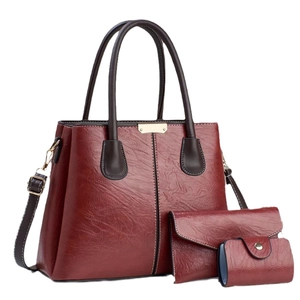 Three-piece dark red leather handbag set with large tote, wallet and card holder
