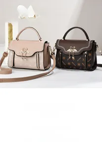 Detail of retro patterned handbags with elegant swan heart hardware and pearl chain