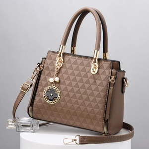 Brown geometric embossed tote bag with clover charm and adjustable strap for women