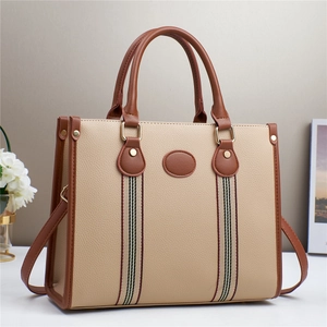 Elegant beige pebbled leather tote bag with brown trim and decorative striped webbing