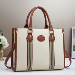 Elegant cream tote bag with brown leather trim and striped ribbon for women