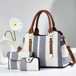 Detailed view of striped 3-piece bag set with tote, pouch, and golden hardware accents