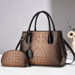Brown crocodile pattern tote and pouch set with black handles and gold hardware