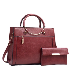 Burgundy faux leather handbag set with matching clutch and gold metal hardware