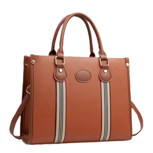 Caramel brown pebbled leather tote bag with red and blue striped ribbon details