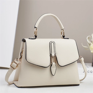 Chic cream leather handbag with crossbody strap shown at a 45-degree angle view