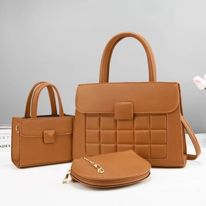Detailed view of 3-piece brown tote bag set with quilted texture and chain strap