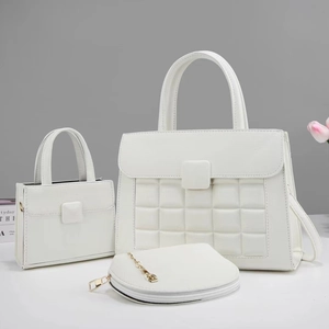 Detailed view of white leather tote bag 3-piece set with embossed texture and accessories