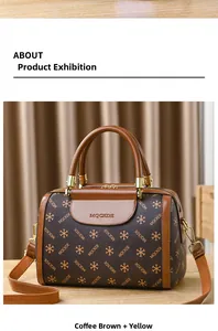 Detail of Boston bag with MQCKDE pattern, brown leather texture and gold hardware