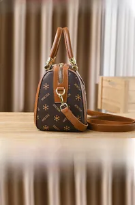 Detail view of the brown monogram Boston bag showing the side and back profile