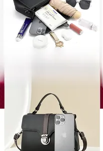 Internal view of black textured leather bag showing capacity for phone and cosmetics