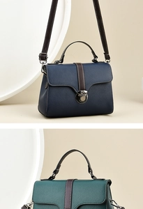Detail of lychee pattern leather bags with metal buckle and shoulder strap in dark green