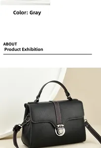 Detail of dark grey lychee leather handbag featuring white contrast stitching and silver snap