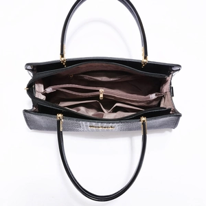 Minimalist black faux leather tote bag with large capacity and multi-pocket interior