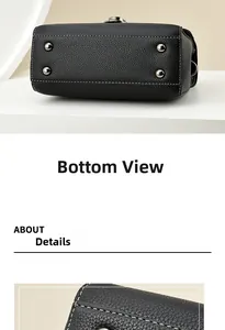 Detail view of black litchi grain leather bag base with silver studs and white stitching