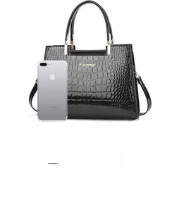 Detailed view of black crocodile pattern handbag showing interior capacity with smartphone