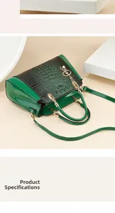 Detail of green and black crocodile texture handbag with gold handle and pearl charm