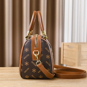 Deep brown Boston handbag with MQCKDE monogram print and adjustable shoulder strap