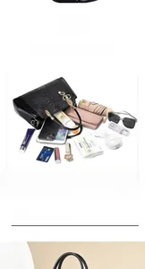 Detail showing spacious black crocodile pattern handbag interior with daily essentials