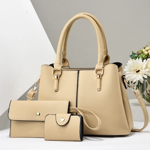 Detailed view of beige 3-piece bag set with tote, clutch and coin purse in pebbled leather