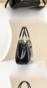 Close-up of black crocodile pattern embossing and glossy finish on a lady handbag
