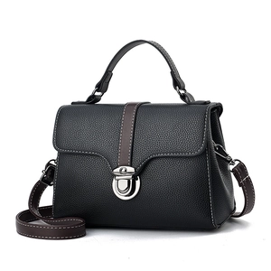Chic black litchi pattern leather handbag with brown straps and silver metal buckle