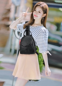 Detail of black woven mini backpack with textured synthetic leather finish for women