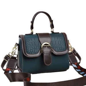 Green and brown flap square bag with crocodile pattern and wide patterned shoulder strap