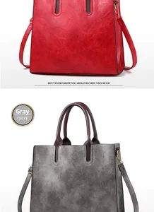 Detailed view of large tote bags in red and grey with retro texture and leather straps