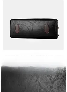 Macro detail of black leather texture and reinforced bottom pads on women's handbag