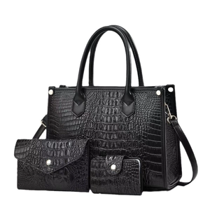 Three-piece black crocodile pattern handbag set with tote, clutch and wallet
