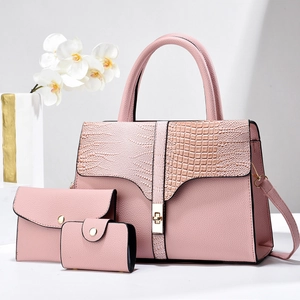 Detailed view of pink three-piece handbag set featuring lychee and croc pattern textures