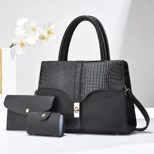 Three-piece set of black faux leather bags with croc texture and gold twist-lock detail