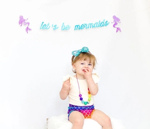 Detail of mermaid baby costume set with sequin headband, beaded necklace and printed diaper cover