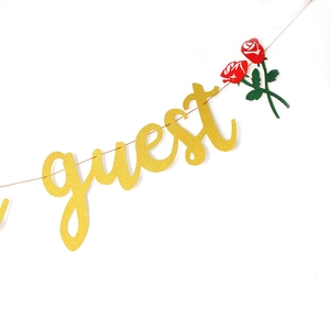 Golden glitter 'Be Our Guest' party banner with red rose accents for wedding decor