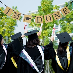 Outdoor graduation party banner with burlap flags and IM DONE text for ceremony decor