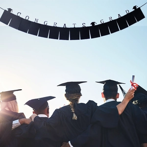 Graduation photo banner with Congrats Grad text and black frames hanging in sunny sky