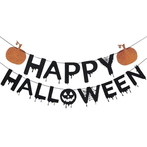 Detail of Happy Halloween banner with orange glitter pumpkins and spider web motifs