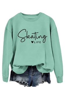 Detail of mint green sweatshirt with Skating Life text and frayed blue denim shorts