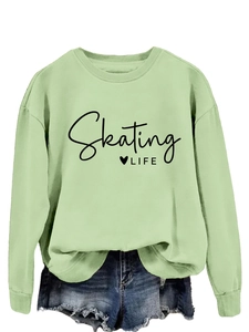 Detail of light green sweatshirt with Skating LIFE print and heart graphic decoration