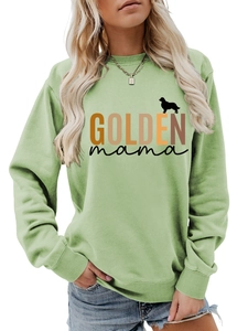 Detail of light green sweatshirt with GOLDEN mama text and golden retriever silhouette