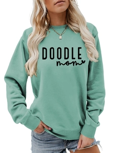 Close-up of the ribbed neckline and black DOODLE mom text on the mint green sweatshirt