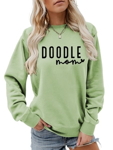 Close-up of the DOODLE mom graphic print and ribbed neckline on this mint green sweatshirt