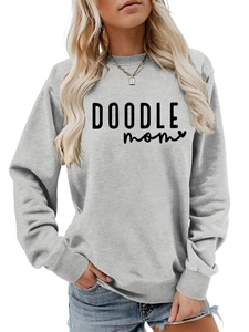 Close-up of DOODLE MOM lettering on a comfortable grey crewneck sweatshirt