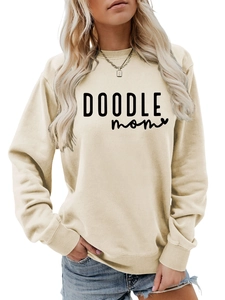 Close-up of DOODLE mom graphic print on cream crewneck sweatshirt with ribbed cuffs
