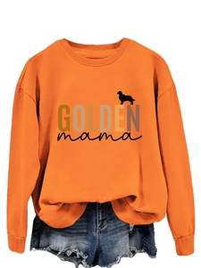 Detail of Golden Mama print on a bright orange crewneck sweatshirt with dog silhouette
